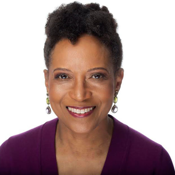 Headshot of Mary C. Curtis, a Black woman wearing a purple top, hear in an up-do and fine earrings, and a bright smile on her face.
